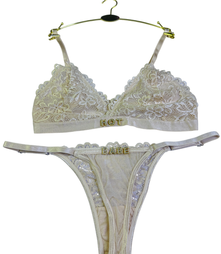 Beige lace bra and thong set on a white background
