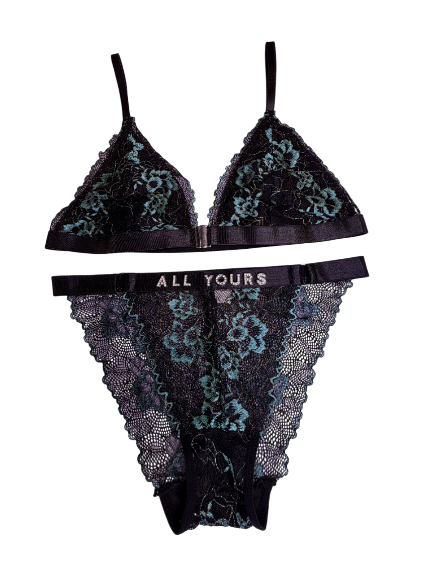 Black lace lingerie set with floral patterns on a white background