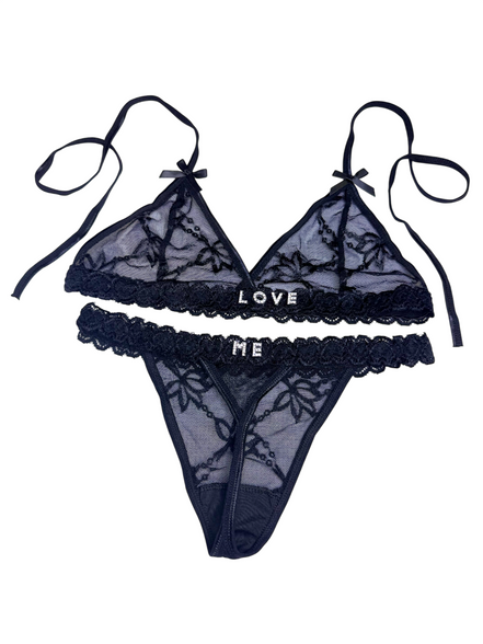 Black lace lingerie set with 'LOVE ME' text on a white background