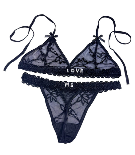 Black lace lingerie set with 'LOVE ME' text on a white background