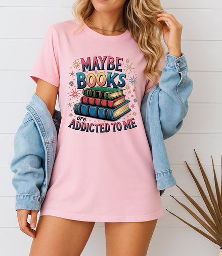Woman wearing pink Maybe Books Are Addicted to Me graphic T-shirt, handmade organic cotton literary fashion tee for book lovers and readers.