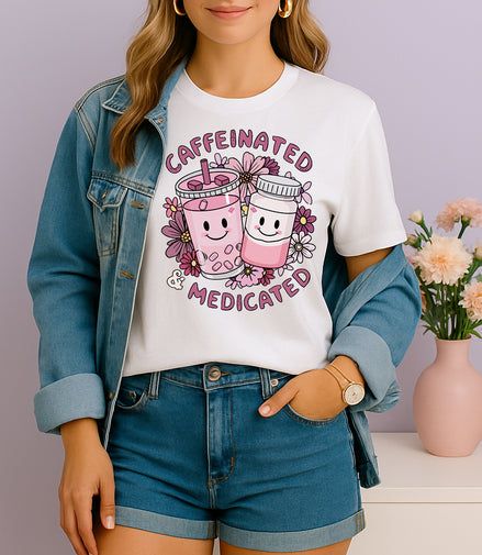 Woman wearing pink Caffeinated and Medicated graphic T-shirt with cute drink and pill bottle design, handmade organic cotton fun fashion tee