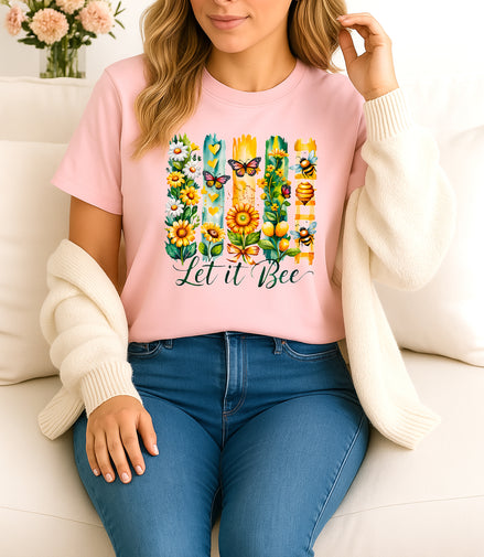 Woman wearing pink Let It Bee floral and bee graphic T-shirt, handmade organic cotton nature-inspired fashion tee with flowers and bees