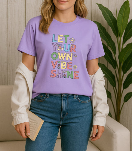 Handmade “Let Your Own Vibe Shine” graphic T-shirt, crafted from organic cotton. Colorful retro design to spread positivity and showcase your unique style.