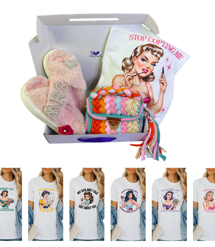 Box containing a colorful bag, pink slippers, and t-shirts with vintage-style graphics.