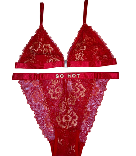 Red lace lingerie set with 'SO HOT' waistband on a white background