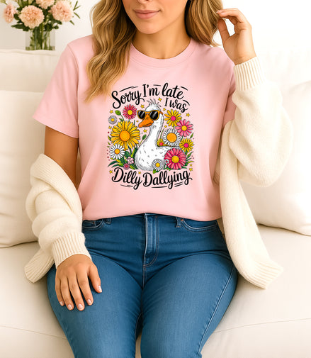 Woman wearing pink Sorry I’m Late I Was Dilly Dallying graphic T-shirt with duck and flowers, handmade organic cotton fun and casual fashion tee