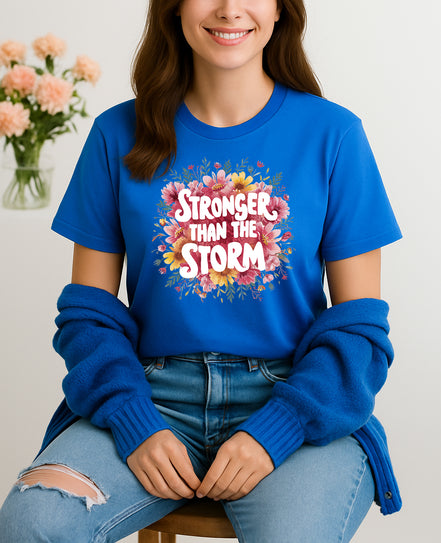Woman wearing blue Stronger Than the Storm floral graphic T-shirt, handmade organic cotton empowering fashion tee