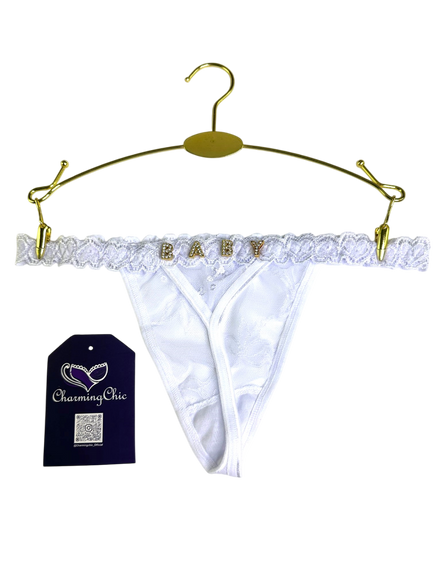 White lace babydoll panties on a gold hanger with 'Charming Chic' tag.
