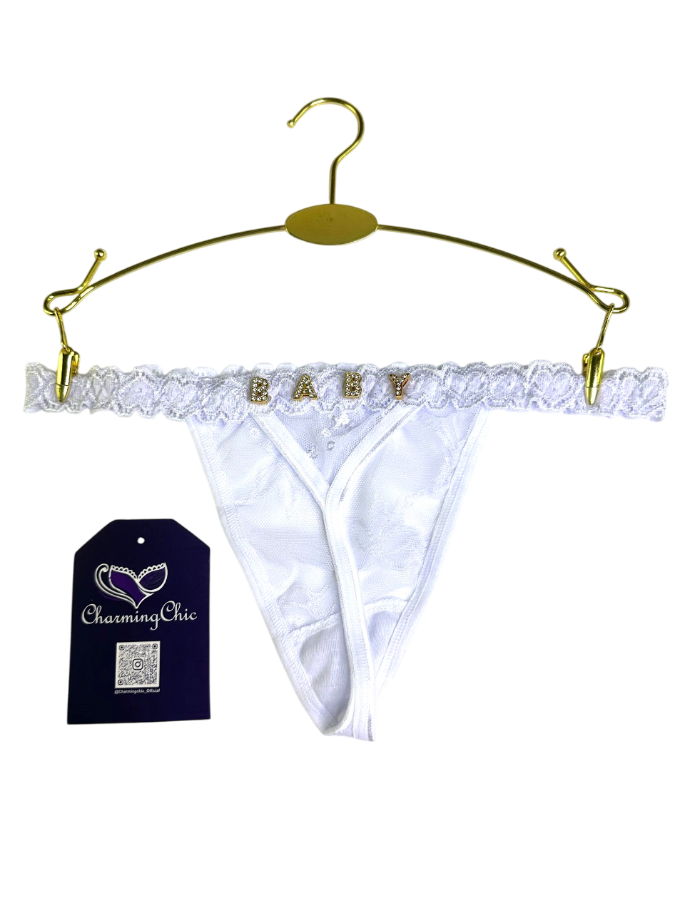 White lace babydoll panties on a gold hanger with 'Charming Chic' tag.