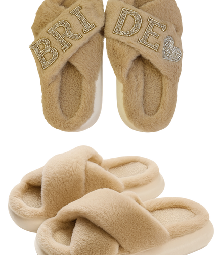 Pair of beige slippers with 'Bride' and heart designs on a white background
