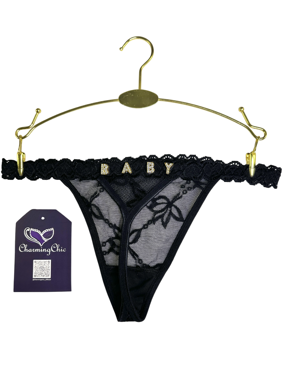 Black lace thong on a gold hanger with 'Charming Chic' tag.
