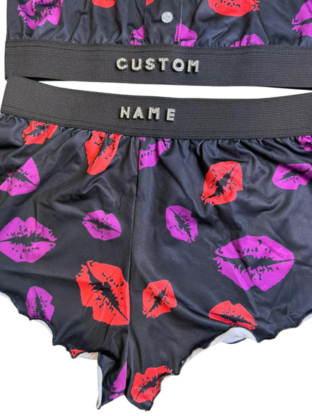 Black underwear with red and pink lip prints and 'Custom Name' label.
