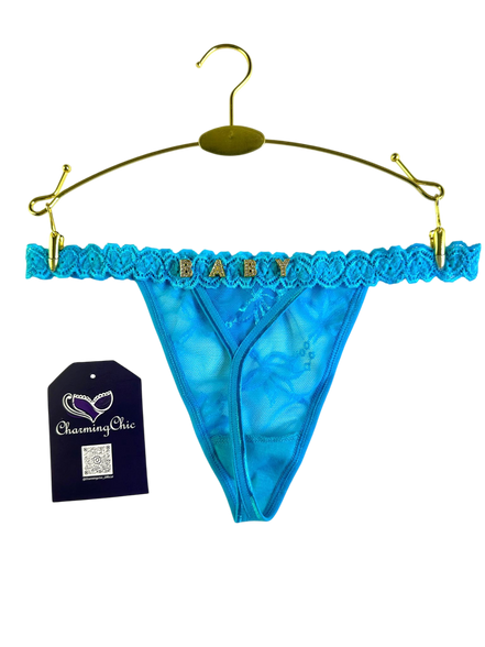 Blue lace thong with 'BABY' text on a hanger, featuring a 'Charming Chic' tag.