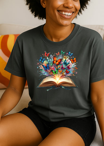 Women wearing a dark gray t-shirt with a colorful graphic of butterflies emerging from an open book.
