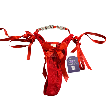 Red velvet thong with ribbons and a tag on a white background