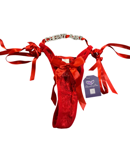 Red velvet thong with ribbons and a tag on a white background