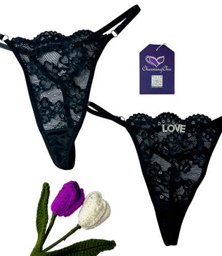 Black lace lingerie set with 'LOVE' embroidery, Charming Sue tag, and decorative flowers on a white background.