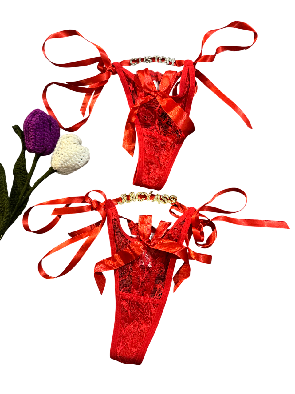 Red satin lingerie set with ribbons on a white background