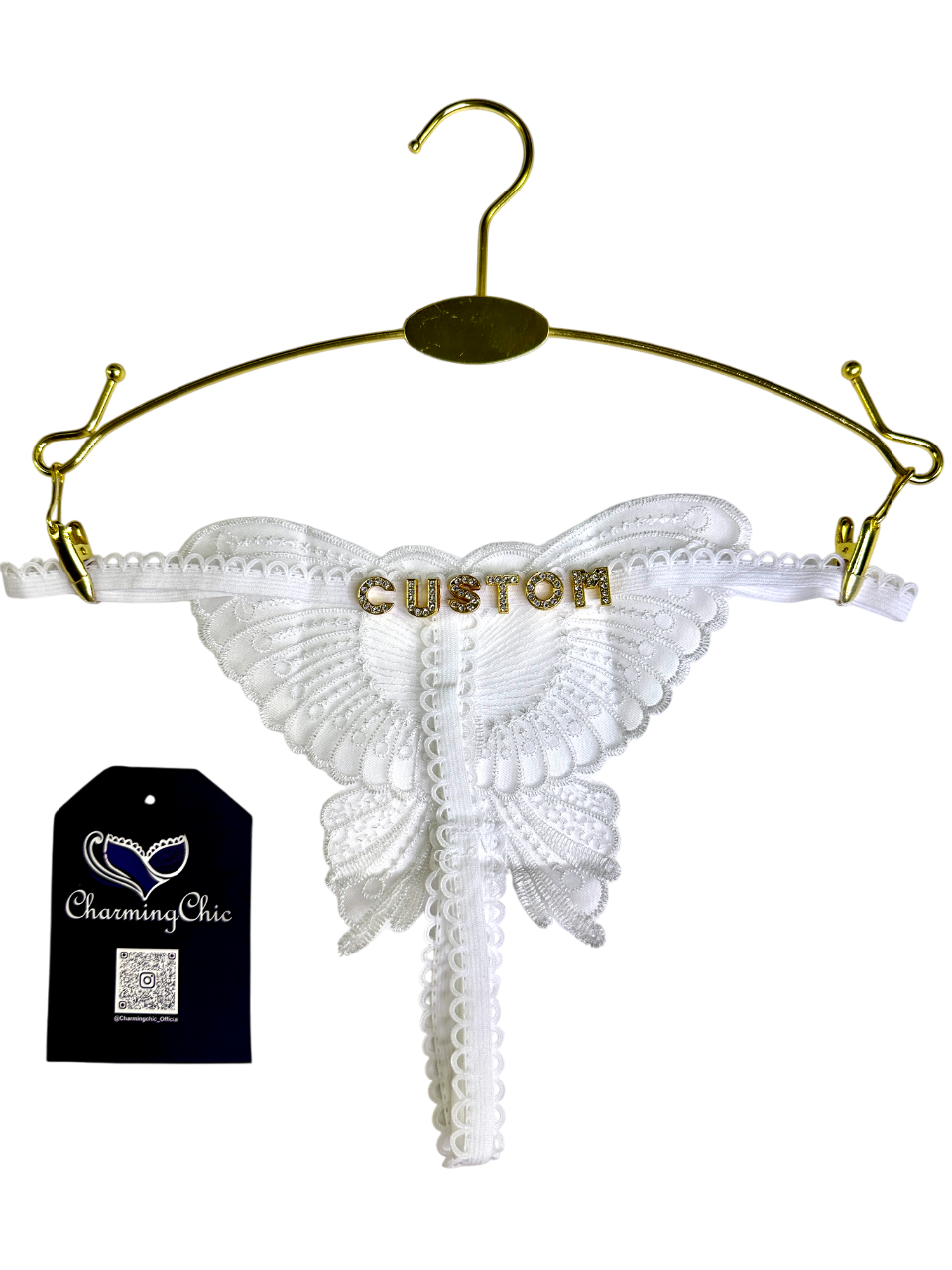 White lace thong with 'CUSTOM' text on a gold hanger, Charming Chic tag visible.