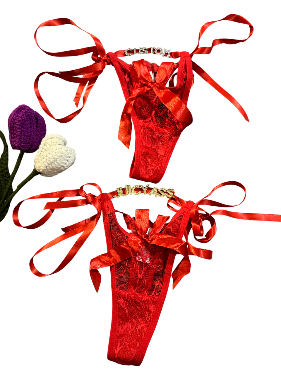 Red satin lingerie set with ribbons on a white background
