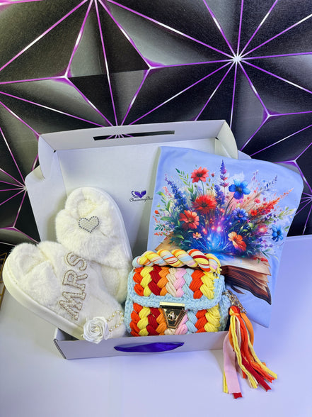 Heart-shaped plush slipper and a colorful bag in a box with a decorative background