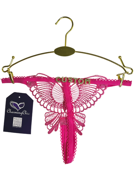 Pink lace lingerie on a gold hanger with 'Charming Chic' tag.