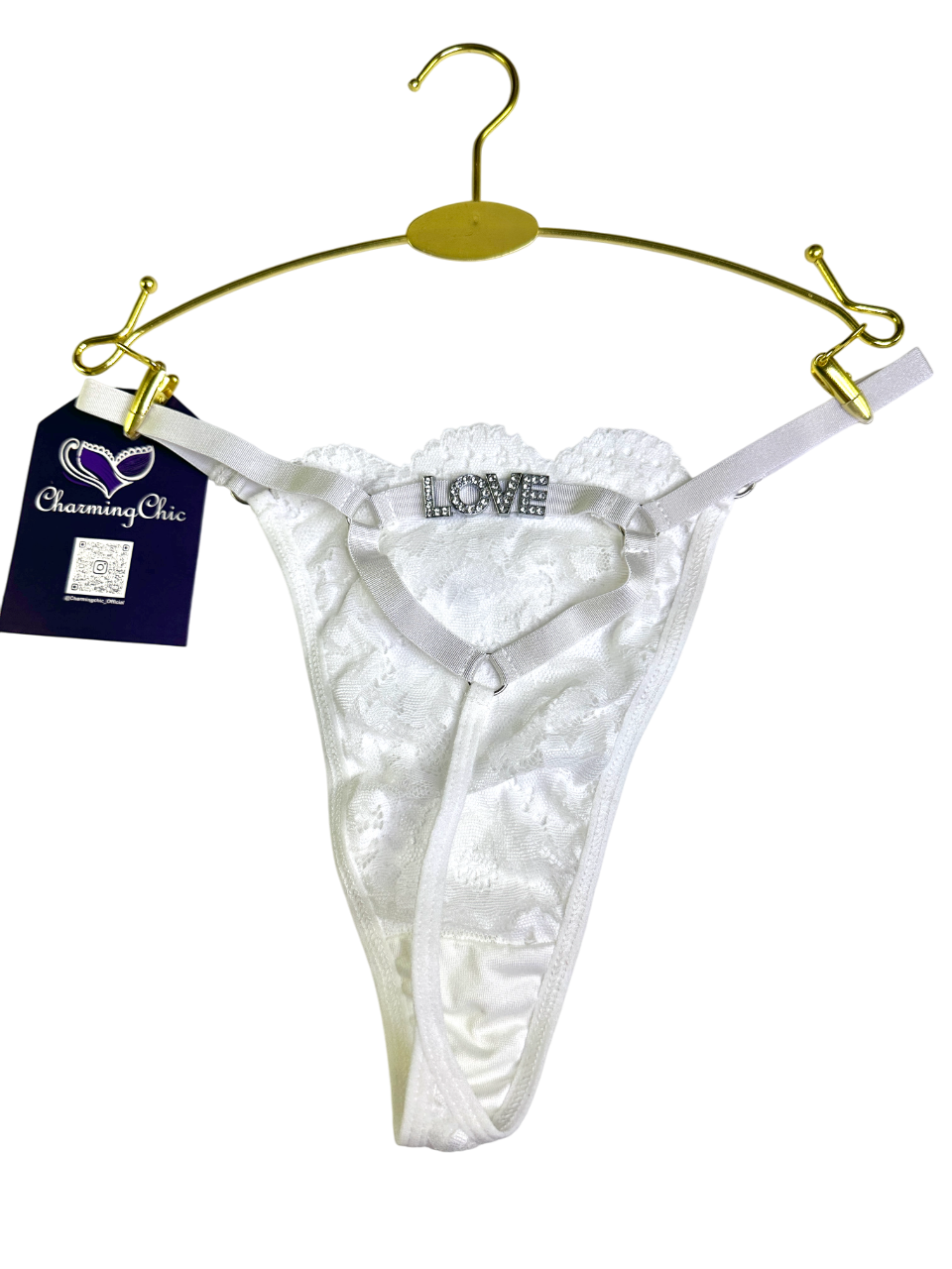 White lace thong with 'LOVE' embroidery on a gold hanger against a white background.