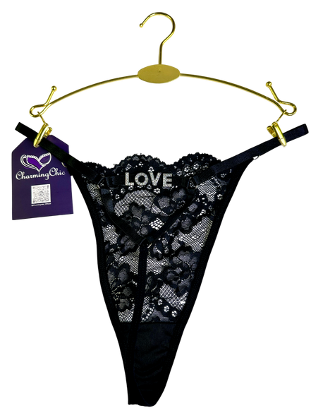 Black lace thong on a gold hanger with 'CharmingOlic' tag, on a white background
