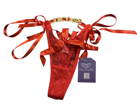 Red lingerie set with gold accents and red ribbons, featuring a purple tag, on a white background.