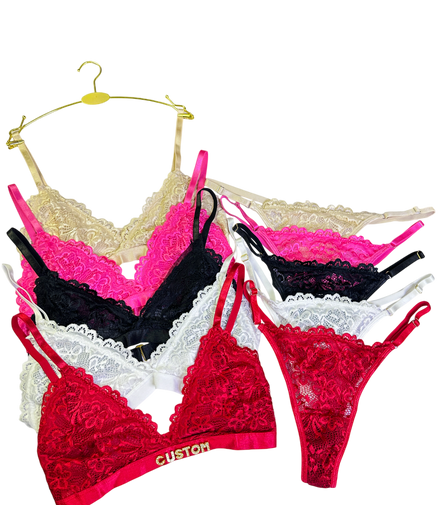 Set of colorful lace lingerie on hangers against a white background