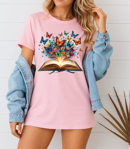 Woman wearing pink butterfly book graphic T-shirt, handmade organic cotton literary fashion tee, styled with denim jacket