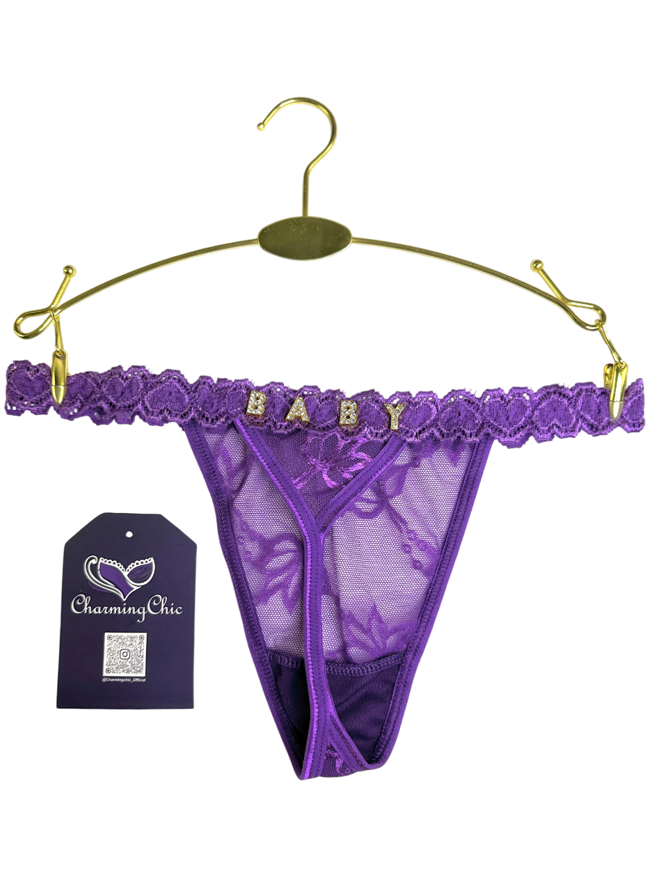 Purple lace thong with 'BABY' lettering on a gold hanger against a white background.