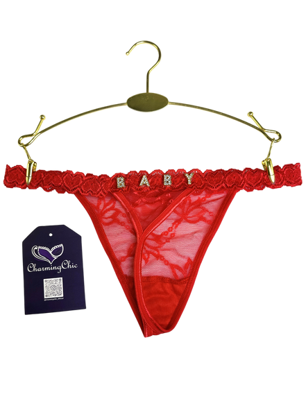 Red lace thong with 'BABY' lettering on a gold hanger, Charming Chic tag visible.