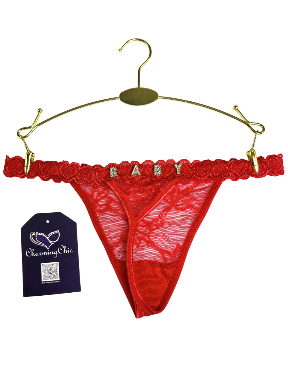Red lace thong with 'BABY' lettering on a gold hanger, Charming Chic tag visible.